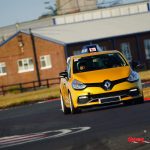 Learner car (automatic) driving around track by driving instructor.